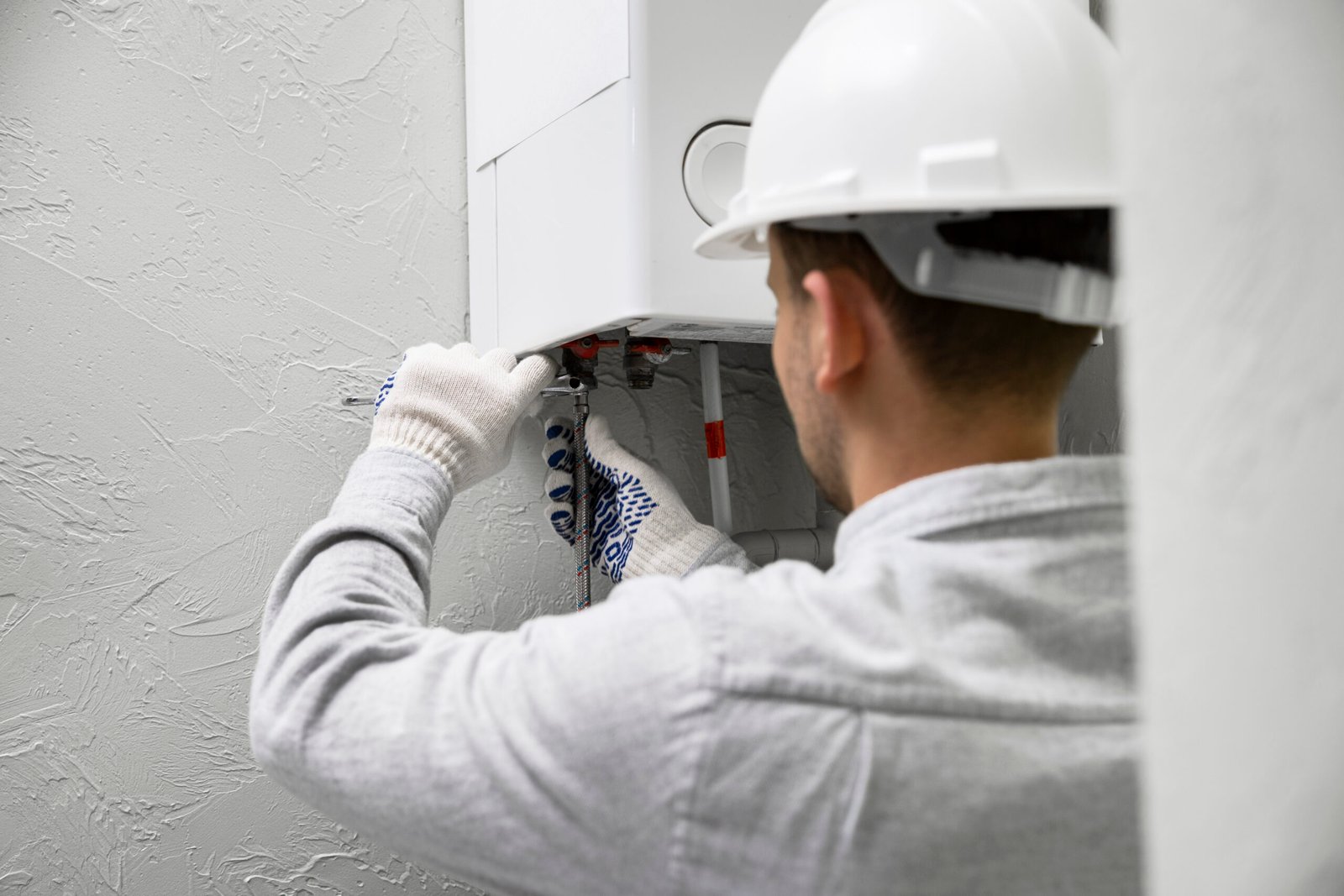 worker repairing water heater scaled